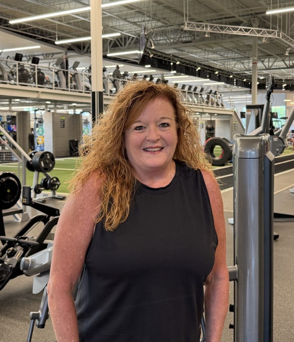 Member of the Month Connie, standing and smiling.